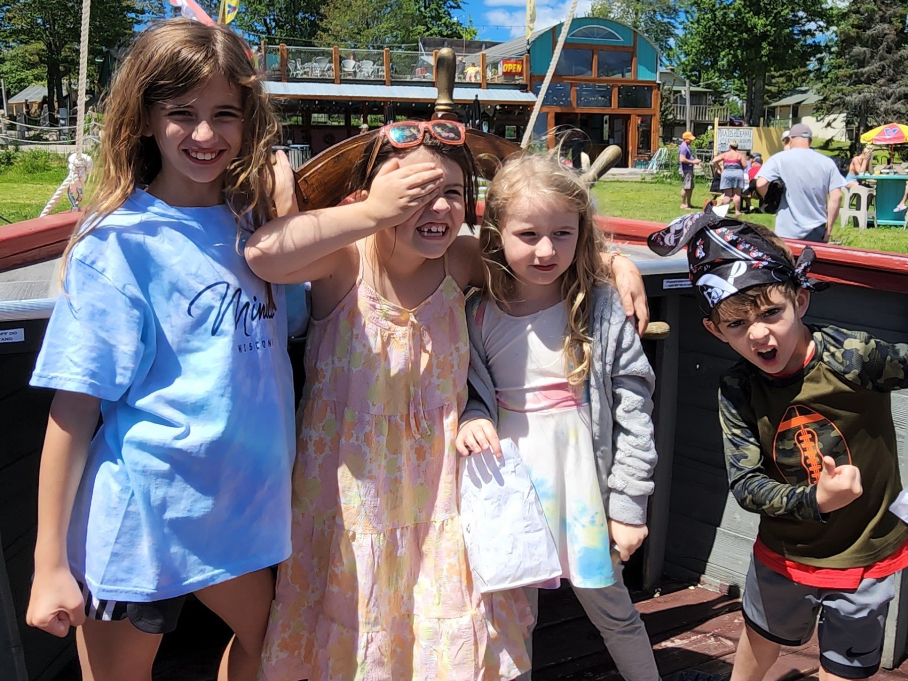 a group of people standing next to a little girl posing for a picture