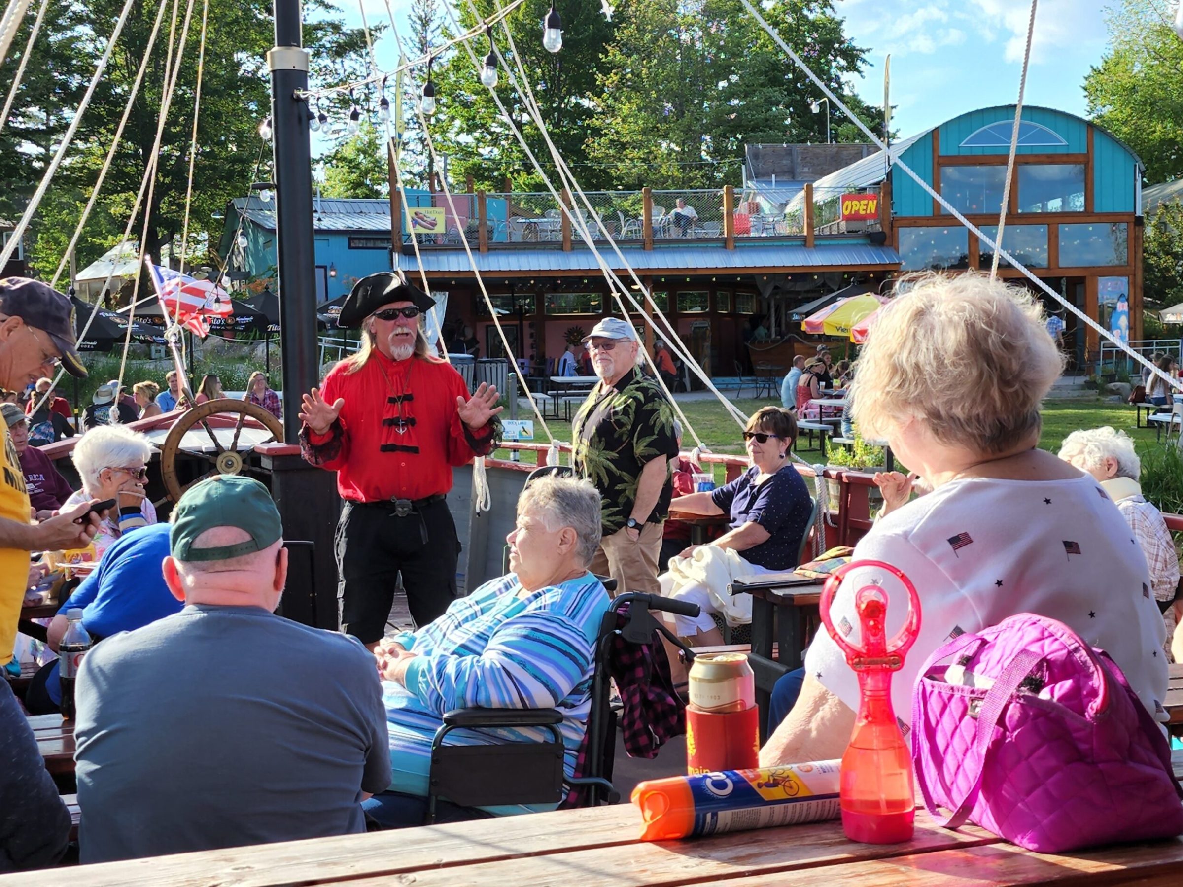 a group of people sitting at a dock