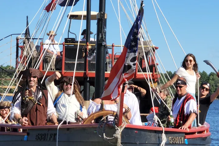 a group of people riding on the back of a boat