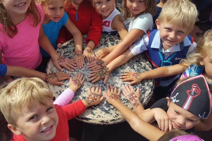 a little girl holding a baby
