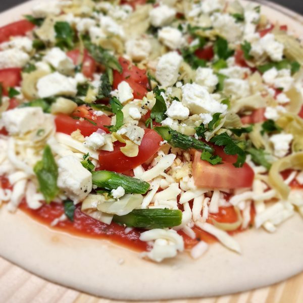 a pizza sitting on top of a plate of food