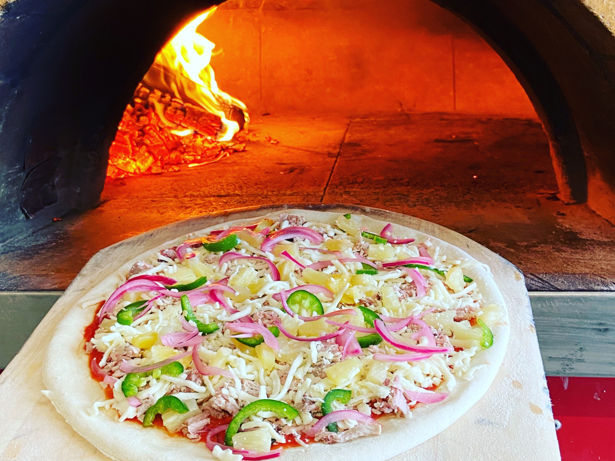 a pizza sitting on top of a pan on a stove top oven